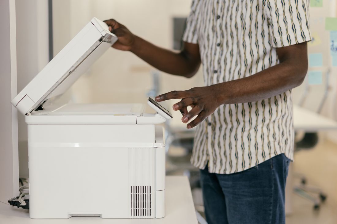 Person at an office multifunction printer